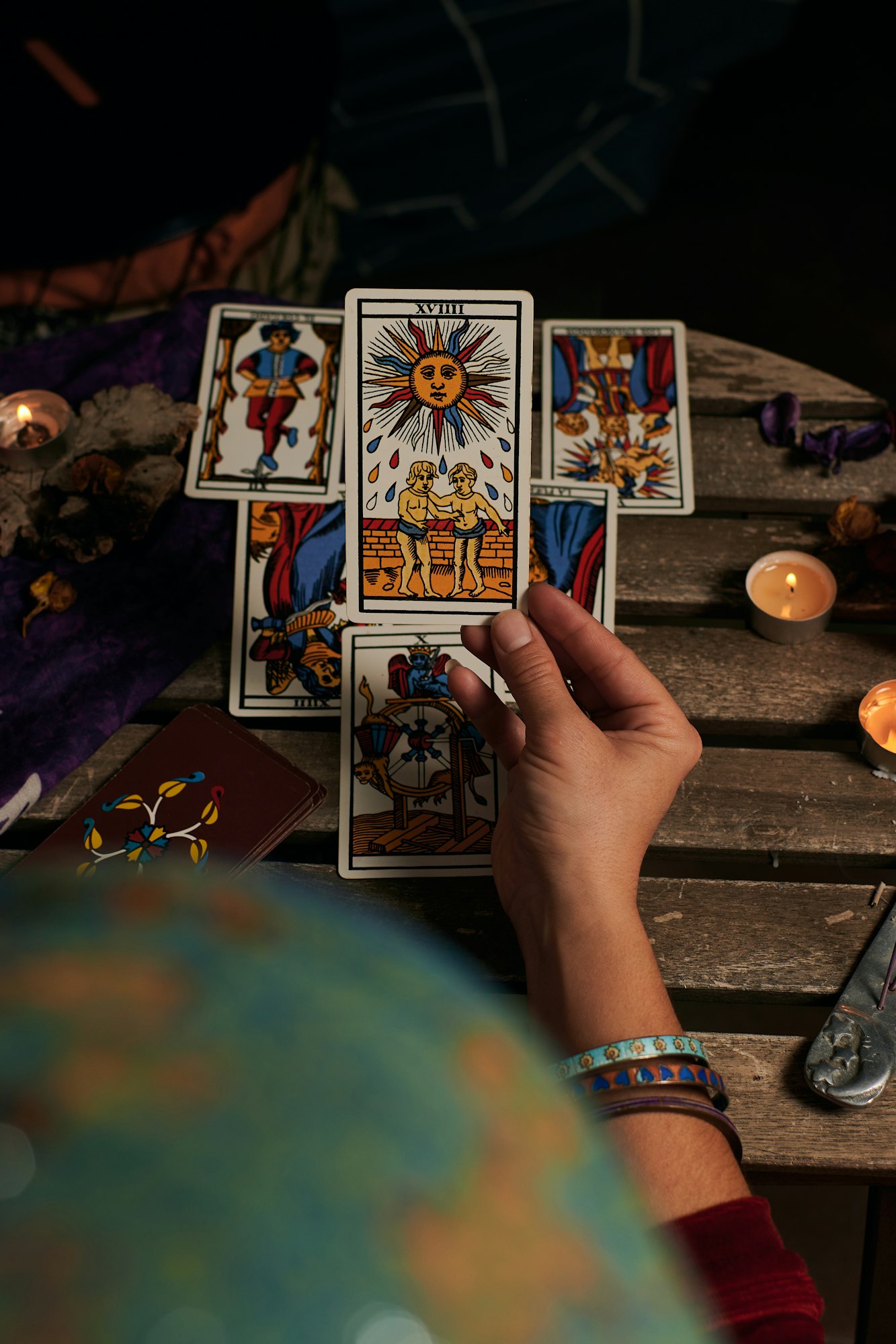 Close-up of a fortune teller reading tarot cards